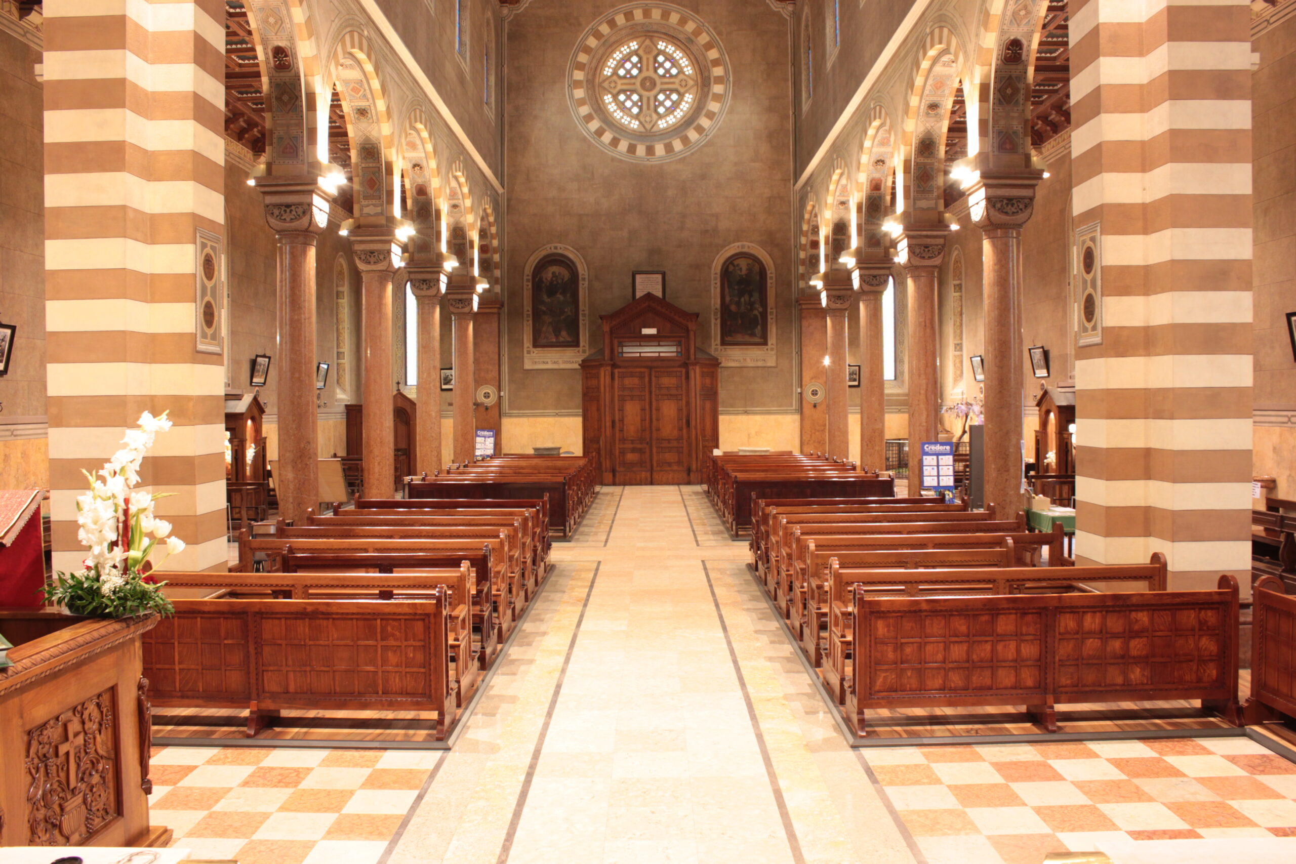 Interno di chiesa con panche in legno pronte per l’installazione di pedane riscaldanti nel 2025